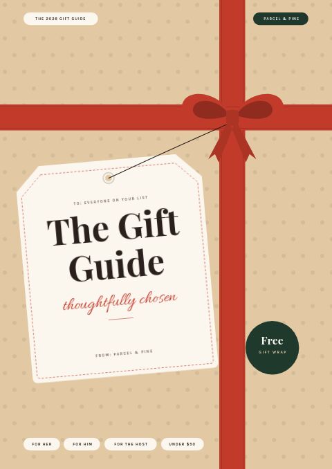 Gift guide cover in kraft paper tied with a red ribbon and bow, with a cream gift tag reading The Gift Guide