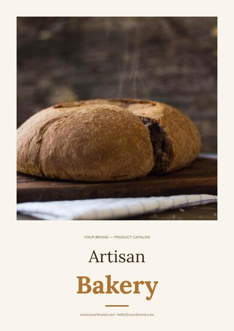 Artisan bakery catalog cover with a framed photo of a crusty loaf on a board above a Lora serif title on cream